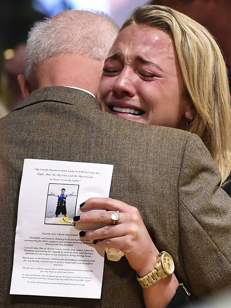 Kelsey Paris becomes emotional as she embraces her grandfather and Sonny Melton's father, James Warren Melton, Monday, Oct. 9, 2017, during Sonny's visitation at Big Sandy High School in Big Sandy ...