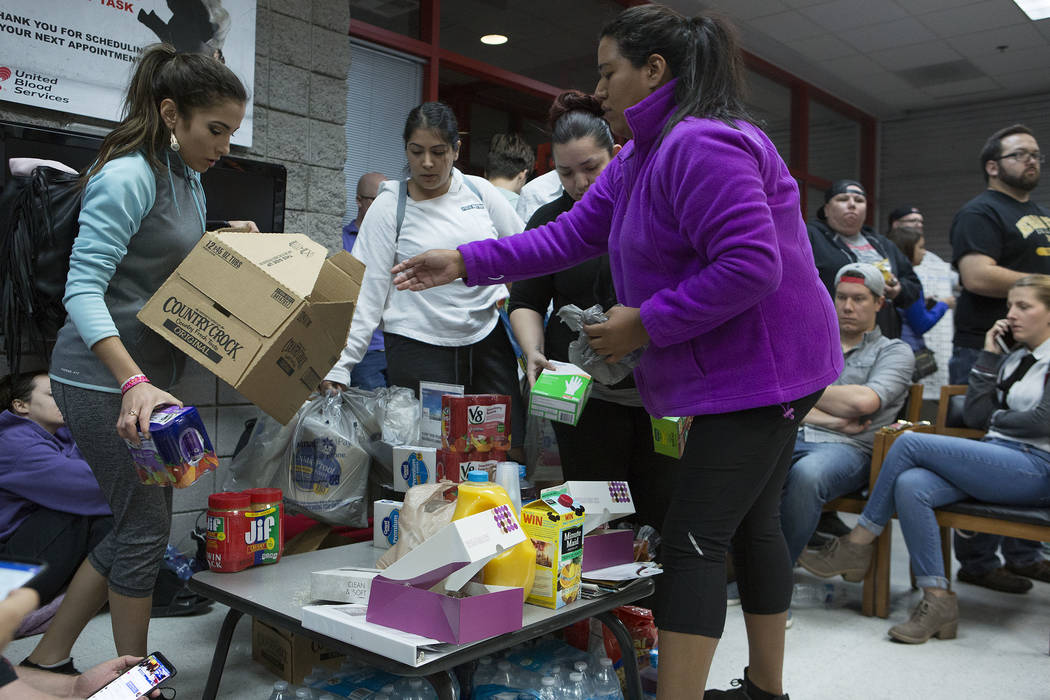 Judith Gonzalez, left and Emily Sandoval bring food donations to those that are waiting to donate blood at United Blood Services in Las Vegas Monday, Oct. 2, 2017, following a shooting on the Stri ...