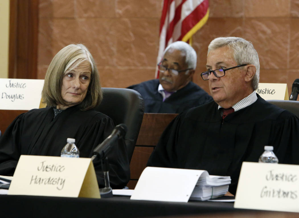 Chief Justice, James Hardesty, right, comments as Chief Justice, Kristina Pickering, looks on, during oral arguments in the legal battle over marijuana distribution at Thomas and Mack Moot Court o ...