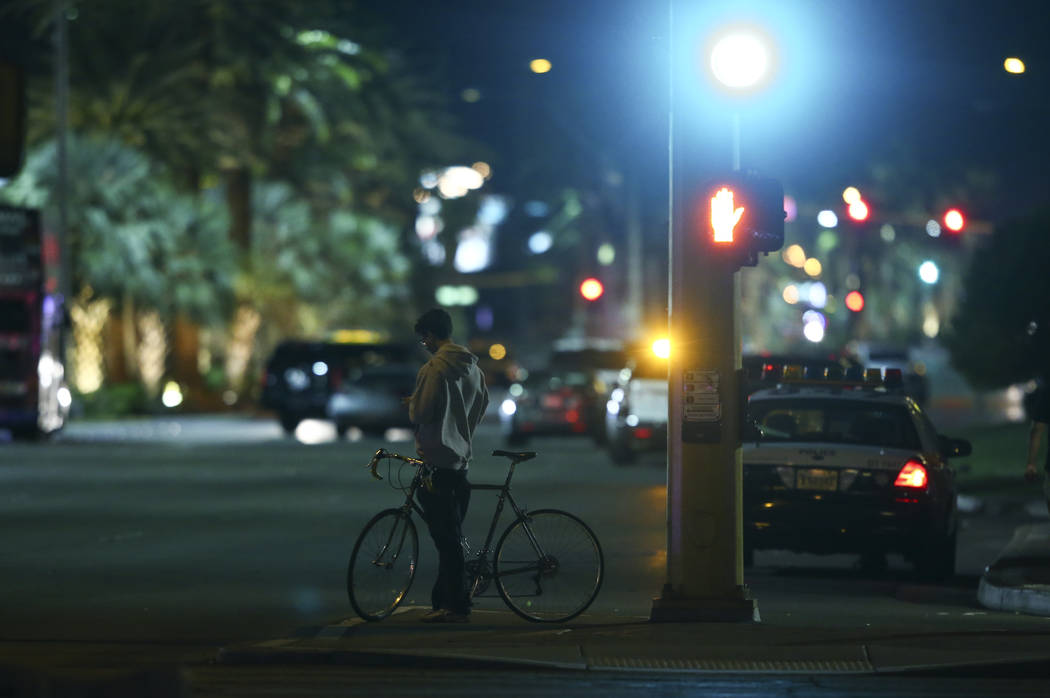 A man takes in the scene outside of the Route 91 festival grounds during the early hours of Monday, Oct. 2, 2017, following an active-shooter situation that left 59 dead and over 500 injured Sunda ...