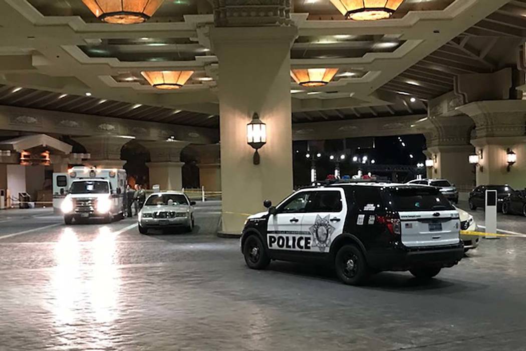 An ambulance and a police car are seen outside the main entrance of Mandalay Bay early Tuesday morning, Oct. 3, 2017. (Todd Prince for the Review Journal)