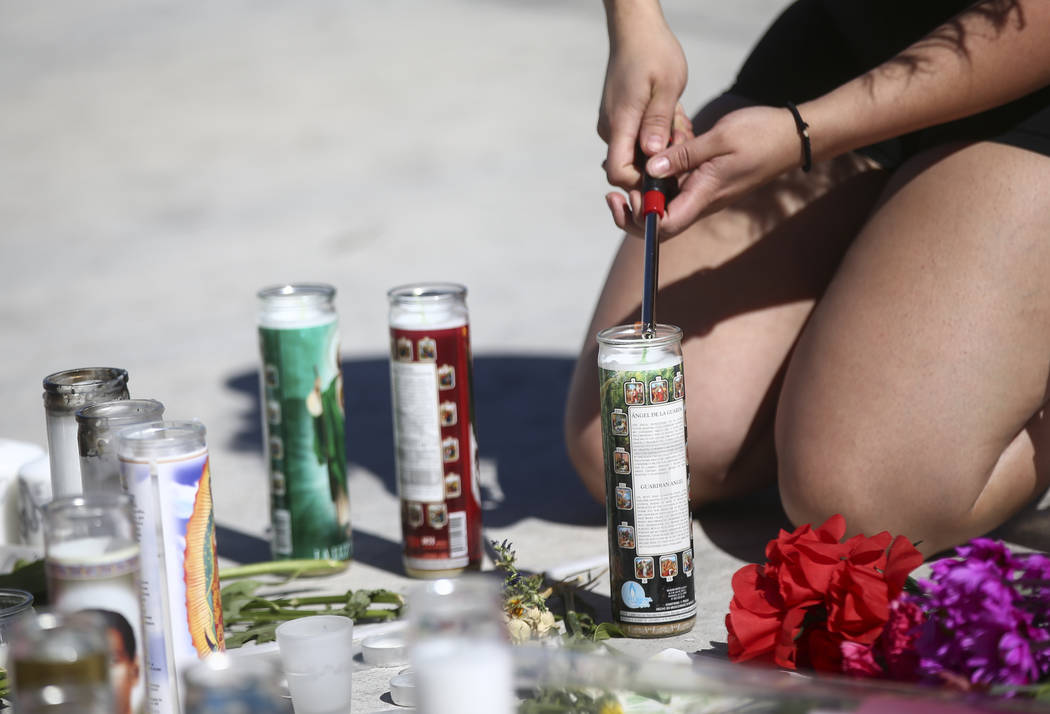 Las Vegas resident Jatziry Yanez lights a candle at a memorial at Las Vegas Boulevard and Sahara Avenue in Las Vegas during the early hours of Tuesday, Oct. 3, 2017. A gunman opened fire on attend ...