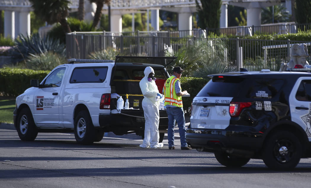 A hazardous materials cleanup crew works near the Route 91 music festival grounds along Las Vegas Boulevard near Reno Avenue in Las Vegas on Tuesday, Oct. 3, 2017. A gunman opened fire on attendee ...