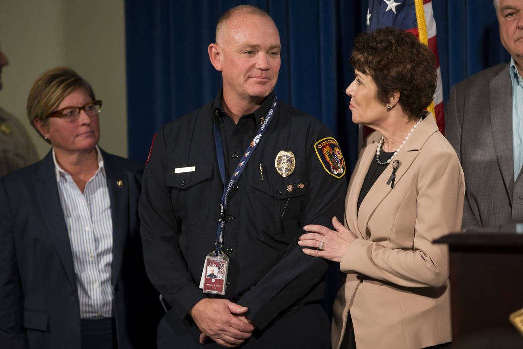 Clark County Fire Chief Greg Cassell, left, and U.S. Rep. Jacky Rosen, D-Nev., during a press conference on the mass shooting at the Las Vegas Metropolitan Police Department headquarters in Las Ve ...