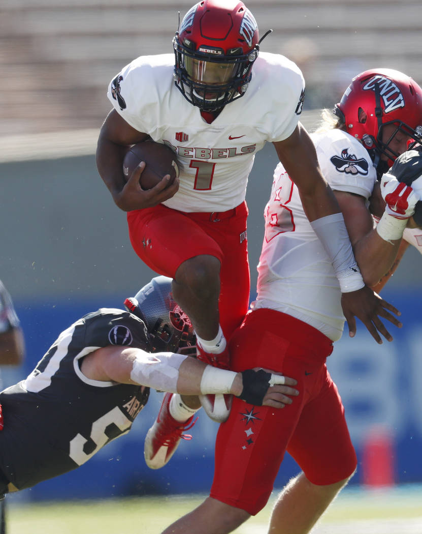 UNLV quarterback Armani Rogers, top, is tripped up by Air Force linebacker Jack Flor for a short gain in the first half of an NCAA college football game, Saturday, Oct. 14, 2017, at Air Force Acad ...