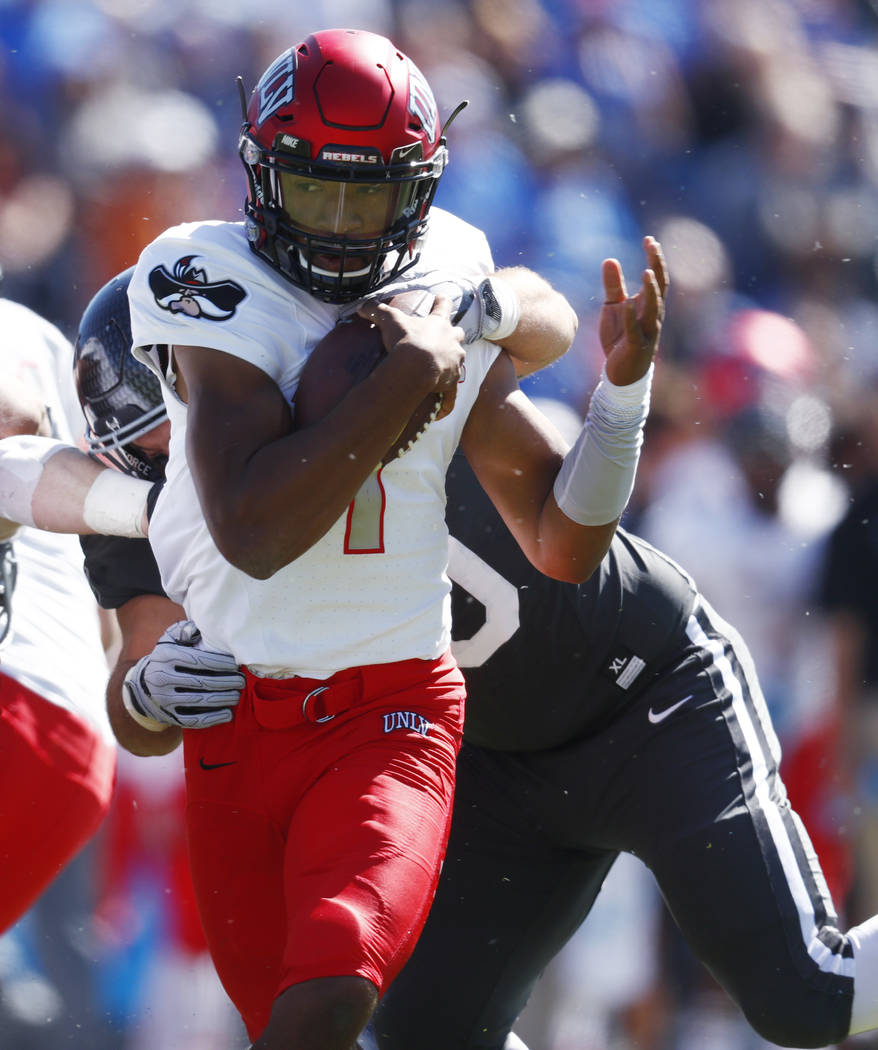 UNLV quarterback Armani Rogers, front, breaks away from Air Force defensive lineman Micah Capra for a short gain in the first half of an NCAA college football game, Saturday, Oct. 14, 2017, at Air ...