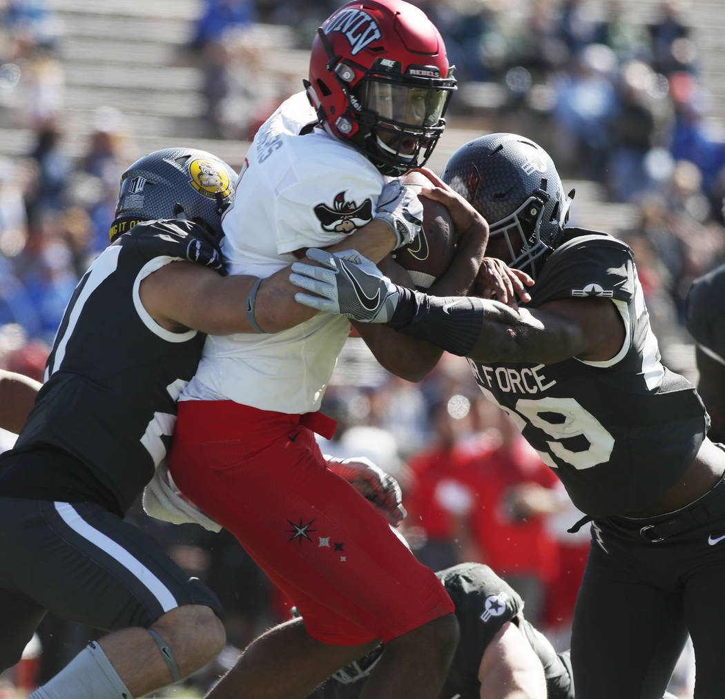 UNLV quarterback Armani Rogers, center, is stopped short of a touchdown run by Air Force defensive backs Jeremy Fejedelem, left, and Kyle Floyd in the first half of an NCAA college football game,  ...