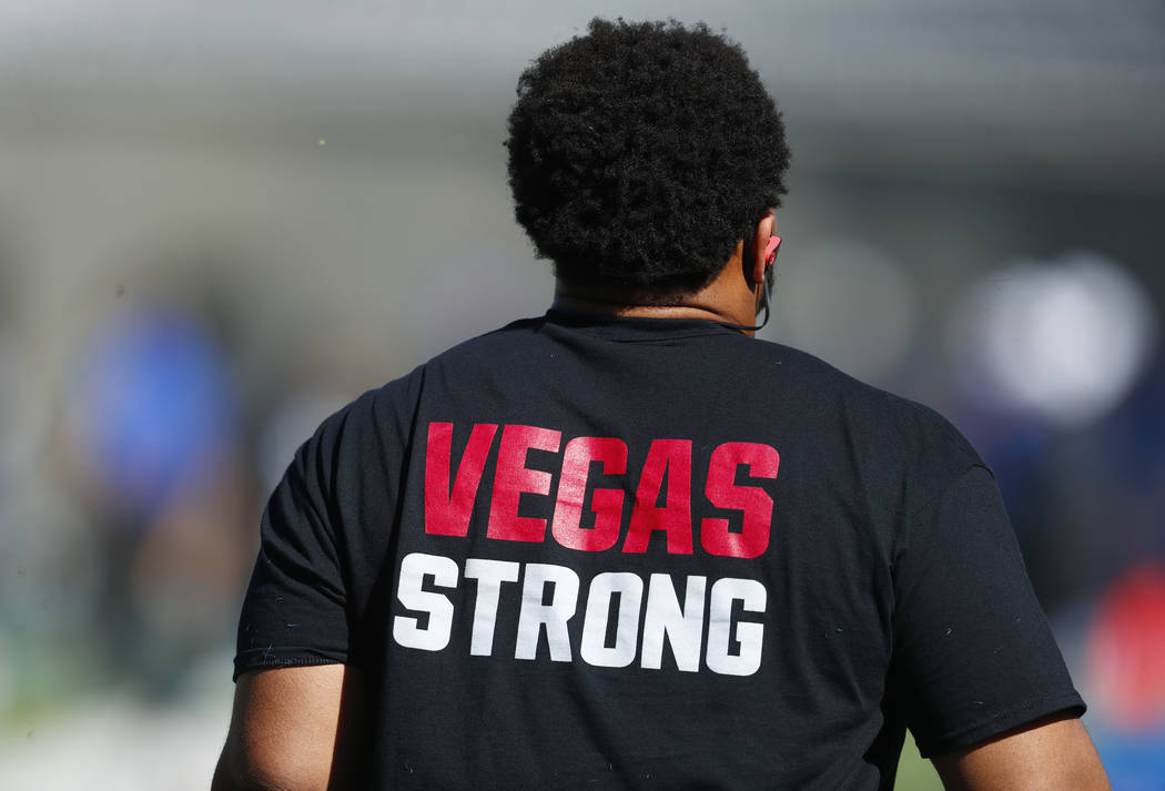 UNLV defensive lineman Mike Hughes Jr. wears a shirt with a message of support for the victims of the massacre in Las Vegas as he warms up before an NCAA college football game against Air Force, S ...