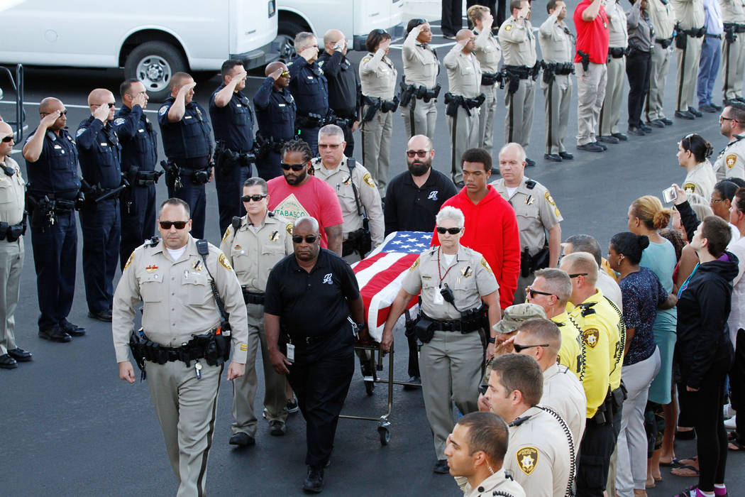 Pallbearers carry the casket of Metropolitan Police Department officer Charleston Hartfield on Tuesday, Oct. 3, 2017, as his casket arrives at Palm Downtown Mortuary and Cemetery in Las Vegas. Har ...