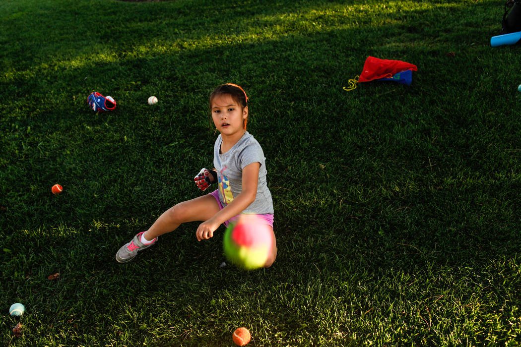 Hailey Dawson, 7, of Henderson, practices her pitch for the MLB World Series opener during a session at Anthem Hills Park in Henderson, Thursday, Oct. 19, 2017. A group of researches at University ...