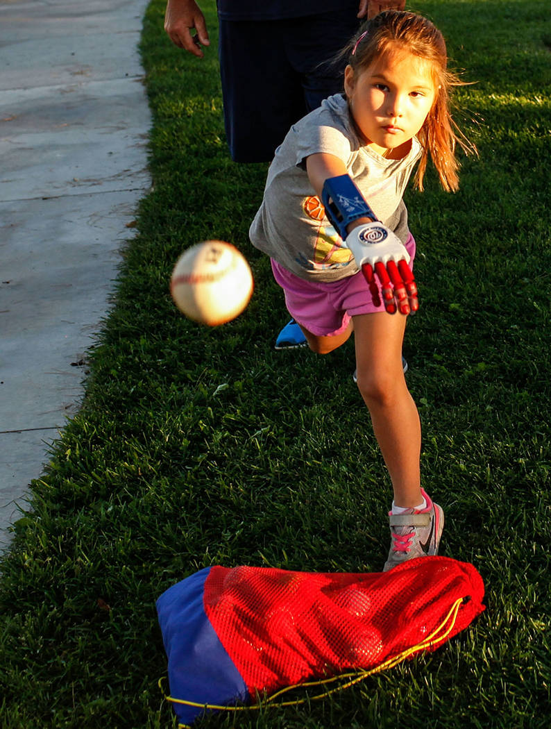 Hailey Dawson, 7, of Henderson, front, practices her pitch for the MLB World Series opener during a session at Anthem Hills Park in Henderson, Thursday, Oct. 19, 2017. A group of researches at Uni ...
