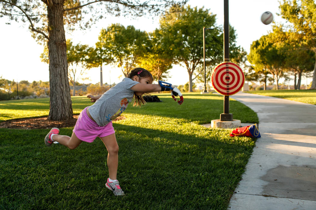 Hailey Dawson, 7, practices her pitch for the MLB World Series opener during a session at Anthem Hills Park in Henderson, Thursday, Oct. 19, 2017. A group of researches at University of Las Vegas  ...