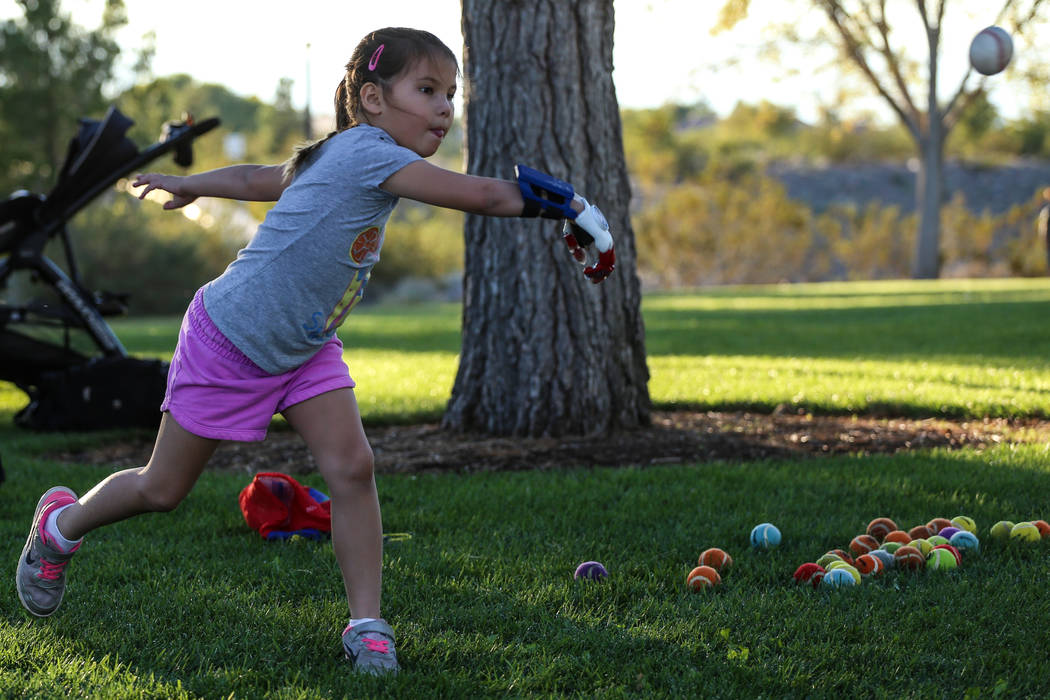 Hailey Dawson, 7, practices her pitch for the MLB World Series opener during a session at Anthem Hills Park in Henderson, Thursday, Oct. 19, 2017. A group of researches at University of Las Vegas  ...