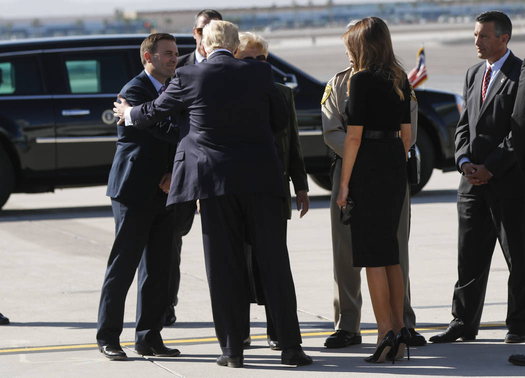 Nevada Attorney General Adam Laxalt, left, greets President Donald Trump, with First Lady Melania Trump, at McCarran International Airport in Las Vegas on Wednesday, Oct. 4, 2017. A gunman opened  ...