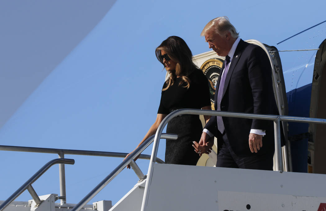 President Donald Trump arrives with First Lady Melania Trump at McCarran International Airport in Las Vegas on Wednesday, Oct. 4, 2017. A gunman opened fire on attendees of a music festival Sunday ...