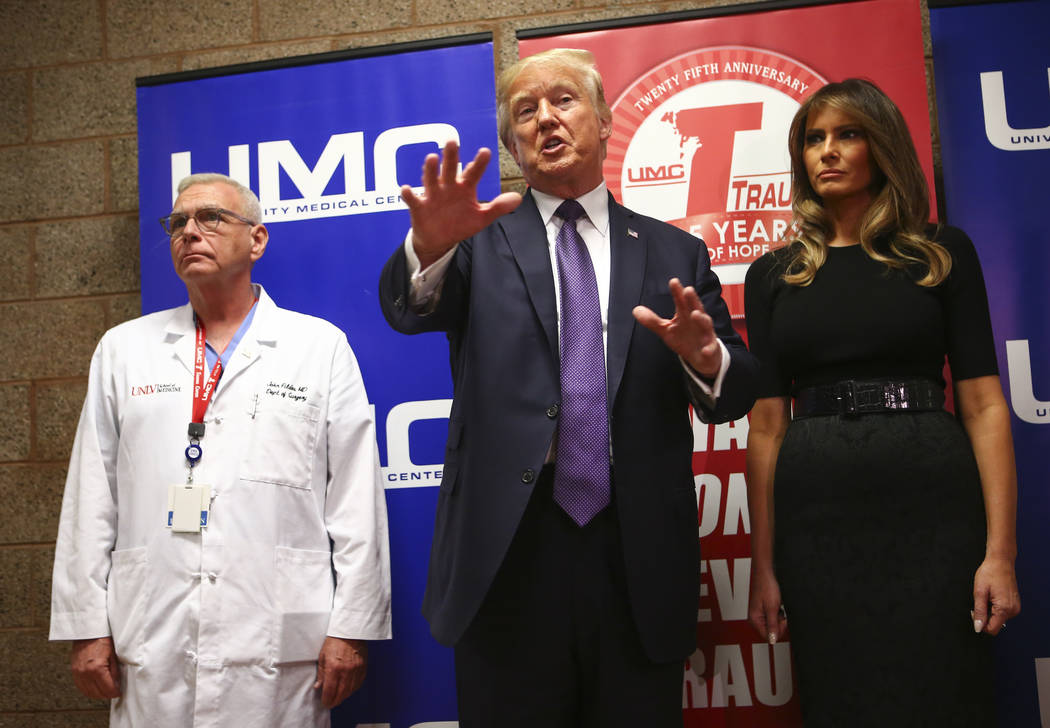 President Donald Trump and First Lady Melania Trump alongside physician John Fildes, left, after visiting victims at University Medical Center in Las Vegas on Wednesday, Oct. 4, 2017. A gunman ope ...