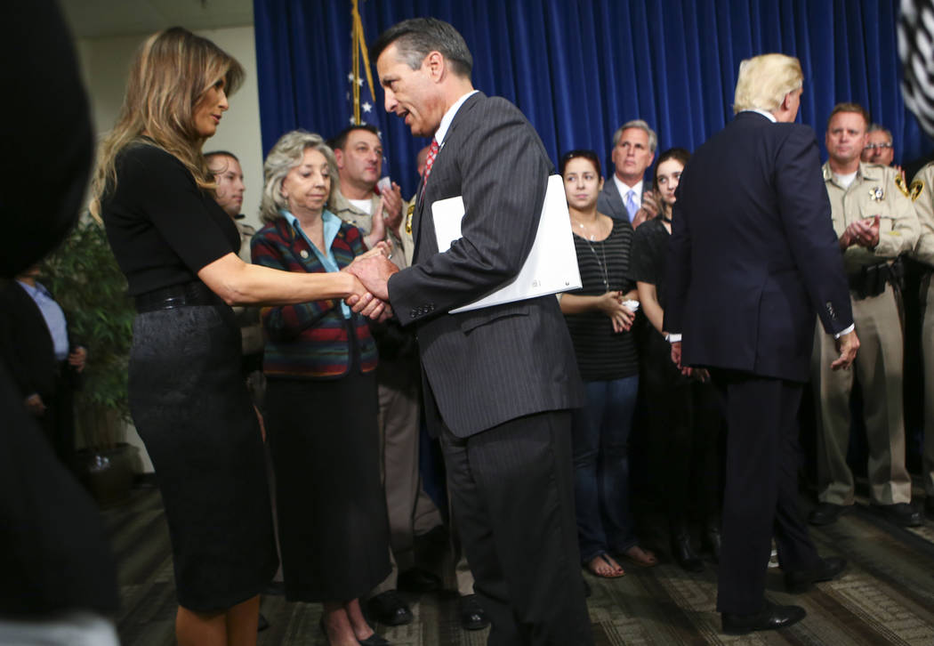 First Lady Melania Trump, left, greets Nevada Gov. Brian Sandoval at Metropolitan Police Department headquarters in Las Vegas on Wednesday, Oct. 4, 2017. A gunman opened fire on attendees of a mus ...