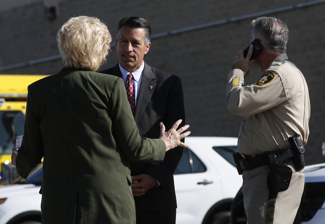 Mayor Carolyn Goodman, from left, Gov. Brian Sandoval, and Clark County Sheriff Joe Lombardo wait for the arrival of President Donald Trump at McCarran International Airport in Las Vegas on Wednes ...