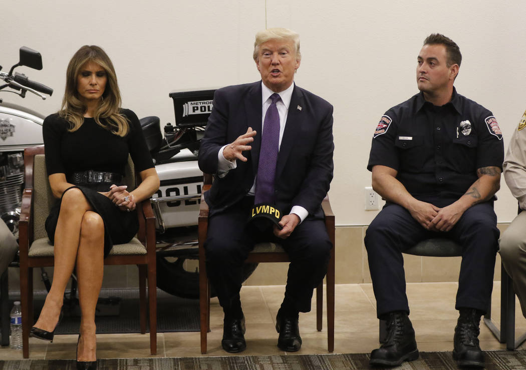President Donald Trump and first lady Melania Trump visit with first responders at Metropolitan Police Department headquarters in Las Vegas on Wednesday, Oct. 4, 2017. A gunman opened fire on atte ...