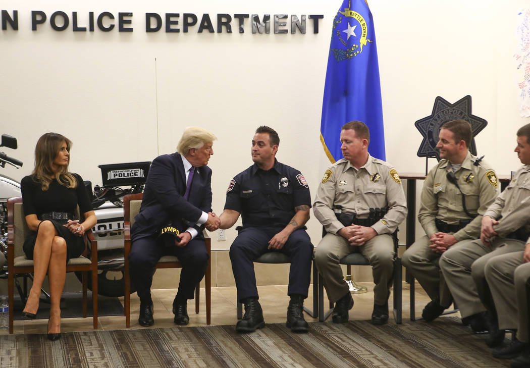 President Donald Trump and first lady Melania Trump visit with first responders at Metropolitan Police Department headquarters in Las Vegas on Wednesday, Oct. 4, 2017. A gunman opened fire on atte ...