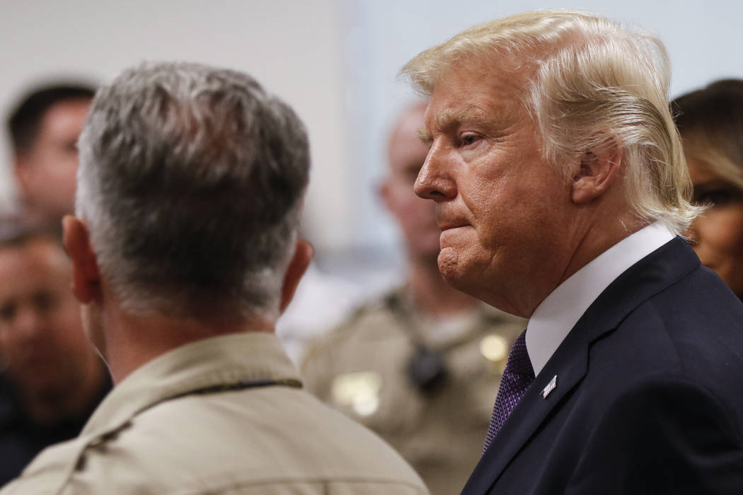 Clark County Sheriff Joe Lombardo, left, and President Donald Trump at Metropolitan Police Department headquarters in Las Vegas on Wednesday, Oct. 4, 2017. A gunman opened fire on attendees of a m ...
