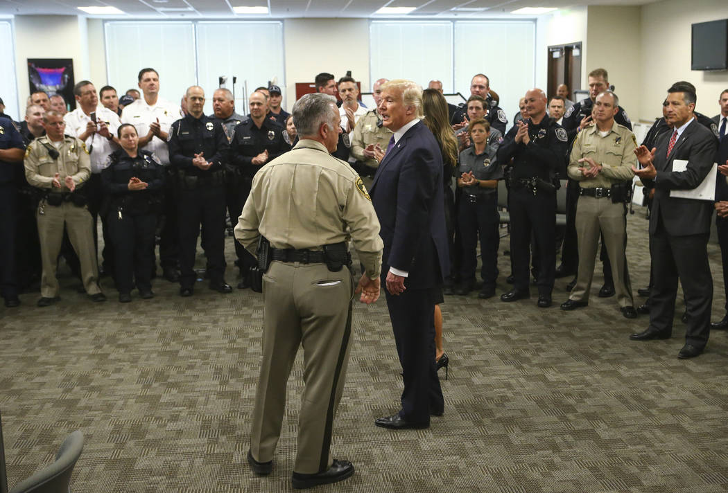 Clark County Sheriff Joe Lombardo, left, and President Donald Trump at Metropolitan Police Department headquarters in Las Vegas on Wednesday, Oct. 4, 2017. A gunman opened fire on attendees of a m ...