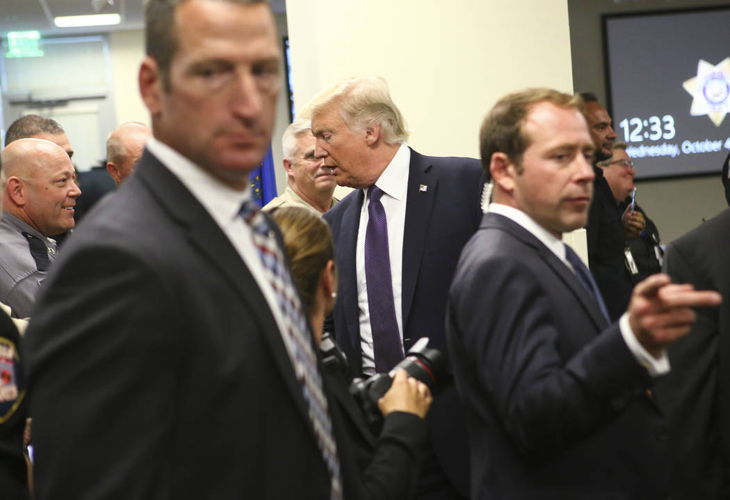 President Donald Trump visits with law enforcement officers at Metropolitan Police Department headquarters in Las Vegas on Wednesday, Oct. 4, 2017. A gunman opened fire on attendees of a music fes ...