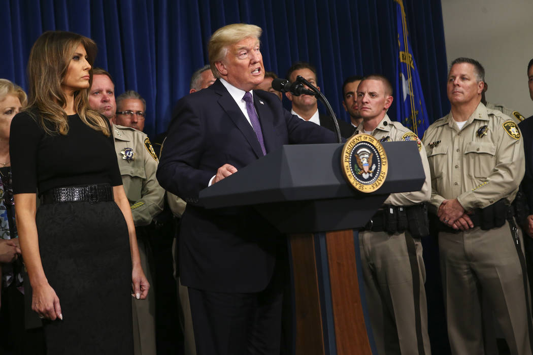 President Donald Trump, with first lady Melania Trump, speaks at Metropolitan Police Department headquarters in Las Vegas on Wednesday, Oct. 4, 2017. A gunman opened fire on attendees of a music f ...
