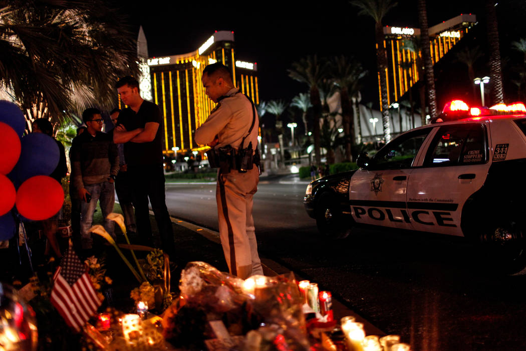 Las Vegas Metro Police Sgt. Charles Jivapong stops by a vigil in remembrance of the mass shooting victims along The Strip nearby Mandalay Bay in Las Vegas, Thursday, Oct. 5, 2017. Joel Angel Juare ...