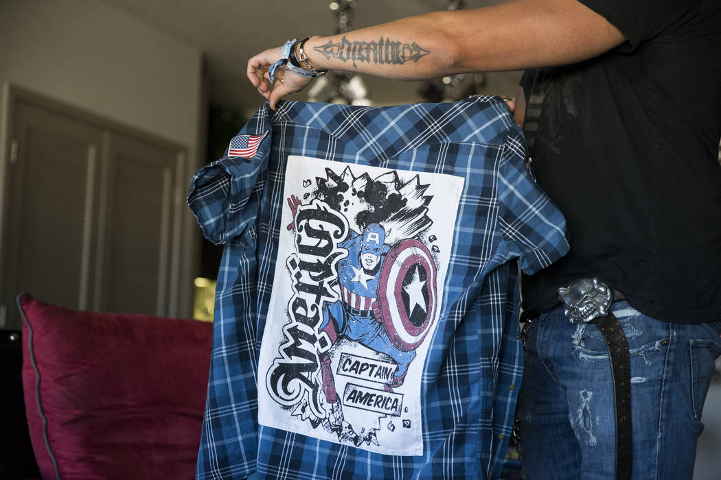 Bryan Hopkins, member of the band Elvis Monroe, and who attended Route 91 festival during the mass shooting last Sunday, shows the shirt he wore during the festival during an interview at his home ...