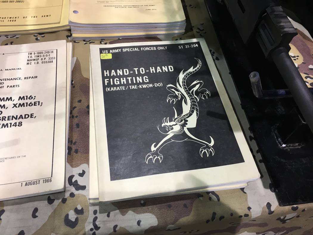 In addition to handguns and rifles, other items for sale included this U.S. Special Forces hand to hand combat manual at the Crossroads of the West Gun Show held in Reno on Saturday, Oct. 7, 2017. ...