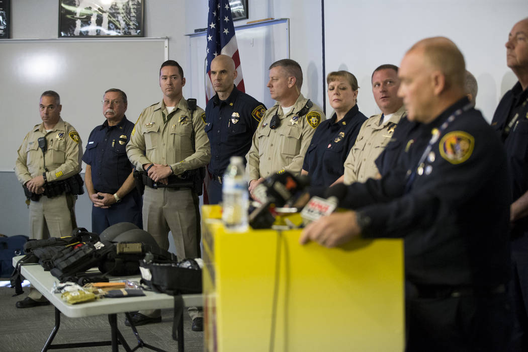 Las Vegas police officers and Clark County firefighters during a press conference on the fire and emergency medical service response to Sundays' mass shooting, at the Clark County Fire Department  ...