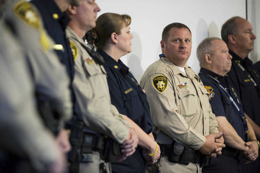 Las Vegas police officers and Clark County firefighters during a press conference on the fire and emergency medical service response to Sundays' mass shooting, at the Clark County Fire Department  ...