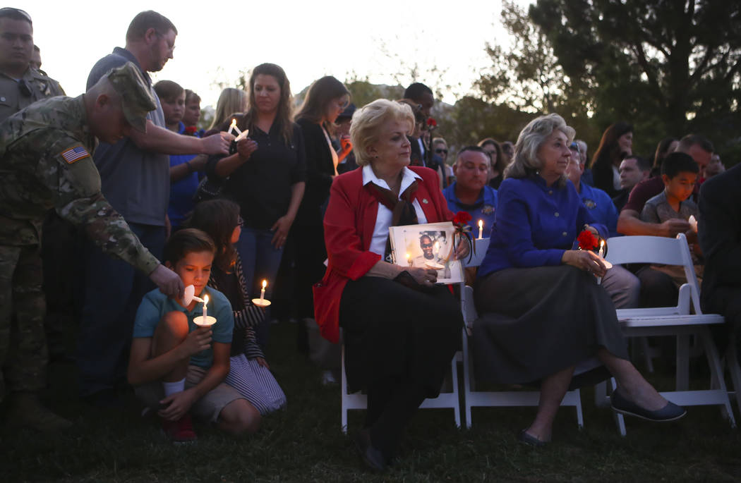 Mayor Carolyn Goodman, center, and U.S. Rep. Dina Titus, D-Nev., right, during a candlelight vigil for Las Vegas police officer Charleston Hartfield, who was killed while off-duty in Sunday's mass ...
