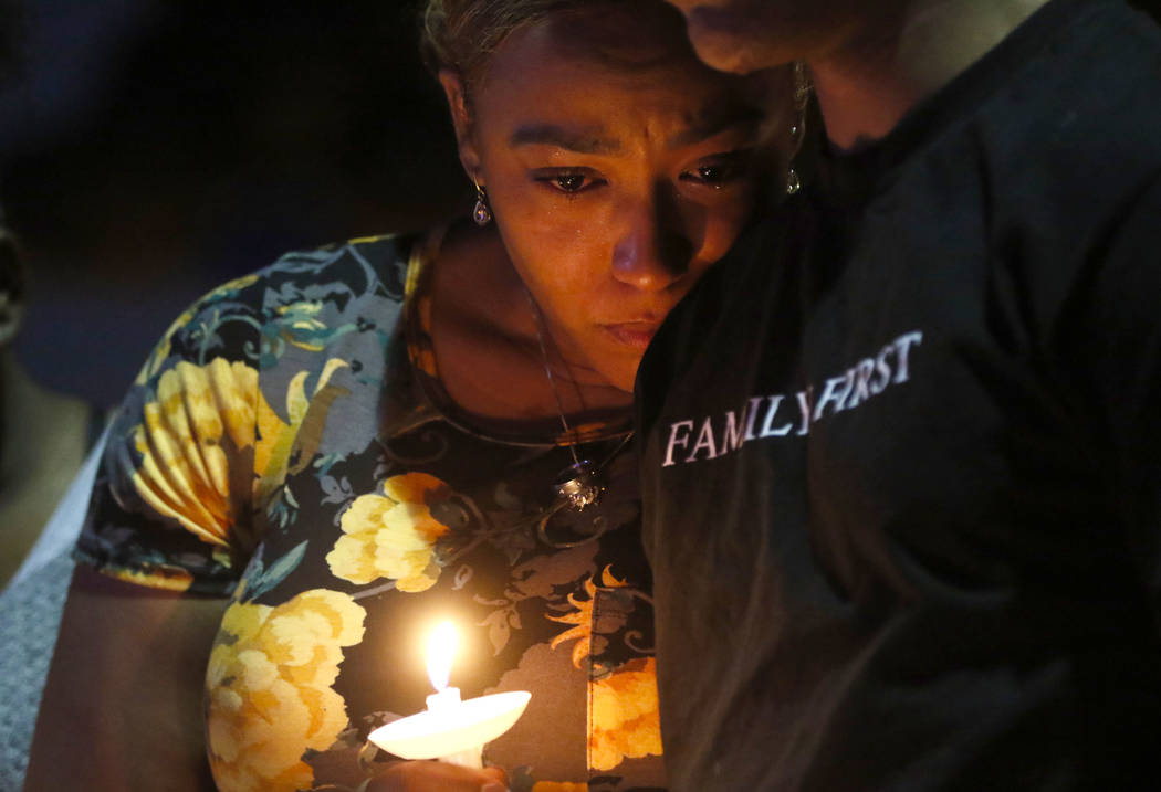 Veronica Hartfield, left, and Ayzayah, wife and son of fallen officer Charleston Hartfield, during a candlelight vigil for in his memory at Police Memorial Park in Las Vegas on Thursday, Oct. 5, 2 ...