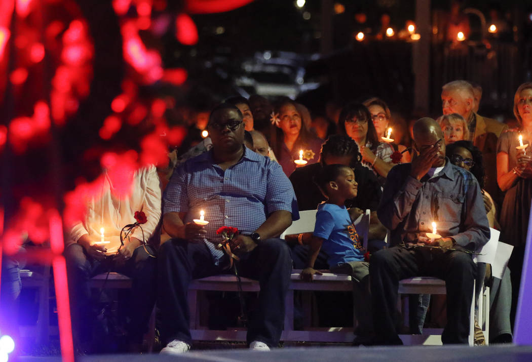 Family and friends during a candlelight vigil for Las Vegas police officer Charleston Hartfield, who was killed while off-duty in Sunday's mass shooting, at Police Memorial Park in Las Vegas on Th ...