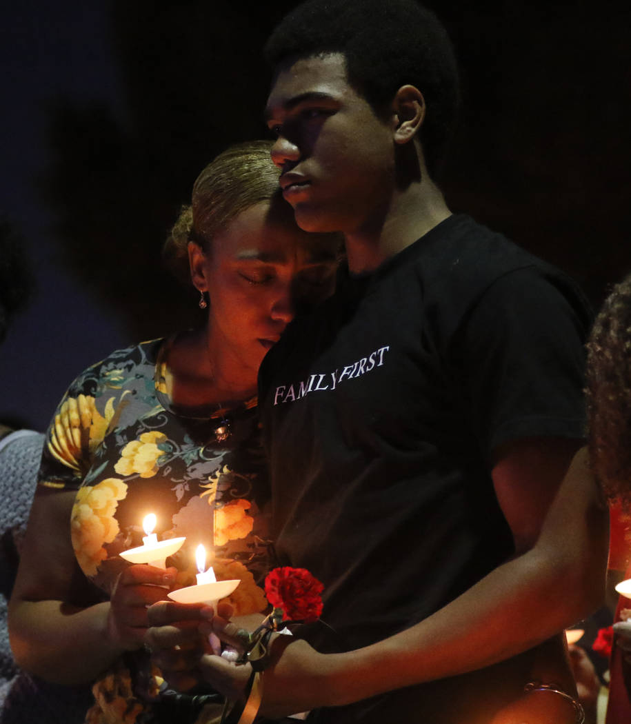 Veronica Hartfield, left, and Ayzayah, wife and son of fallen officer Charleston Hartfield, during a candlelight vigil for in his memory at Police Memorial Park in Las Vegas on Thursday, Oct. 5, 2 ...