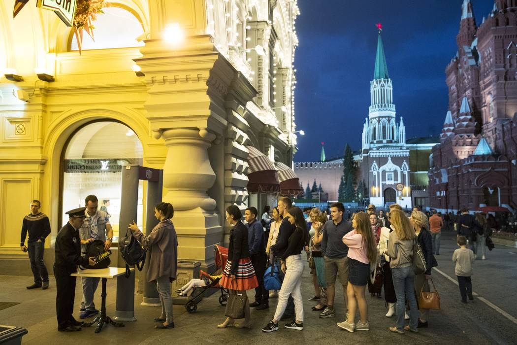 People are checked by security guards before entering GUM, State Shop, at Red square in Moscow, Russia on Wednesday, Sept. 13, 2017. (Pavel Golovkin/AP)