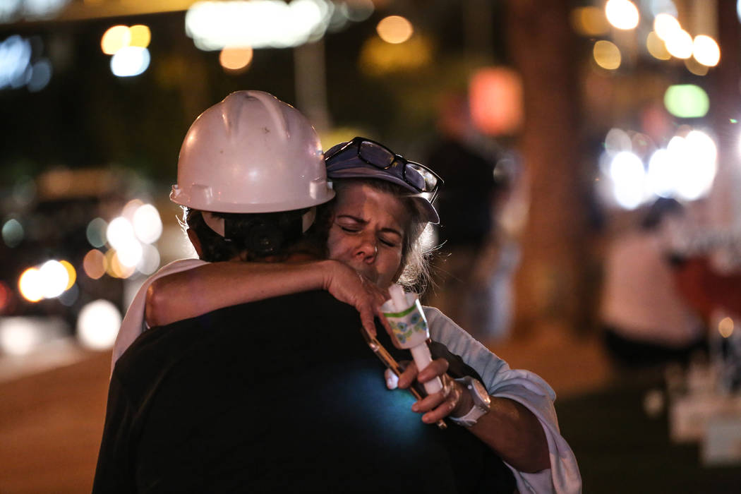 Greg Zanis is hugged by Lee Pex during a vigil in remembrance of the victims of Sunday night's shooting at the Welcome to Fabulous Las Vegas sign in Las Vegas, Thursday, Oct. 5, 2017. Joel Angel J ...