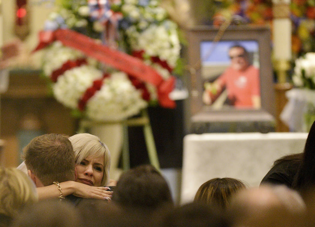 A mourner hugs family members during a memorial service for Jack Beaton at St. Elizabeth Ann Seton Catholic Church in Bakersfield, Calif., on Saturday, Oct. 7, 2017. Beaton was a victim of the Oct ...
