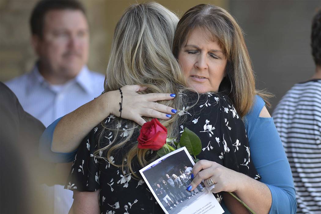Laurie Beaton, right, hugs a mourner after a memorial service for her husband, Jack Beaton at St. Elizabeth Ann Seton Catholic Church in Bakersfield, Calif., on Saturday, Oct. 7, 2017. Beaton was  ...