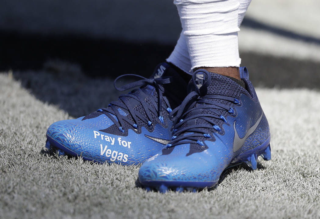 Oakland Raiders wide receiver Cordarrelle Patterson wears cleats to honor the victims in the Las Vegas shooting before an NFL football game against the Baltimore Ravens in Oakland, Calif., Sunday, ...