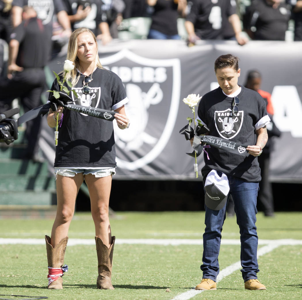 Members of Raider Nation come out before the game with roses and ribbons with names of the fallen on them to pay tribute to the victims of the mass shooting in Las Vegas in Oakland, Calif., Sunday ...