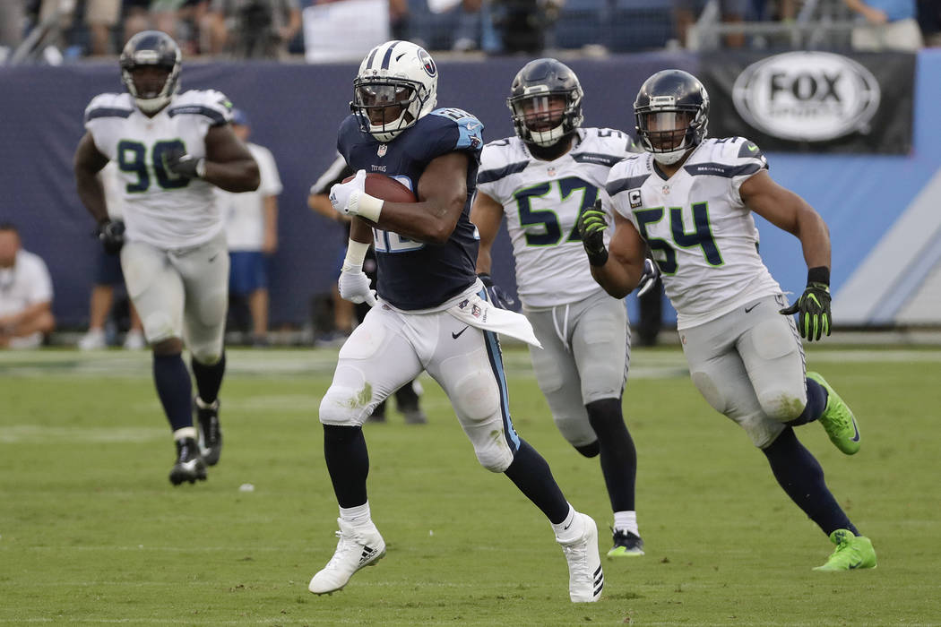 Tennessee Titans running back DeMarco Murray leaves Seattle Seahawks defenders behind as he scores a touchdown on a 75-yard run in the second half of an NFL football game Sunday, Sept. 24, 2017, i ...
