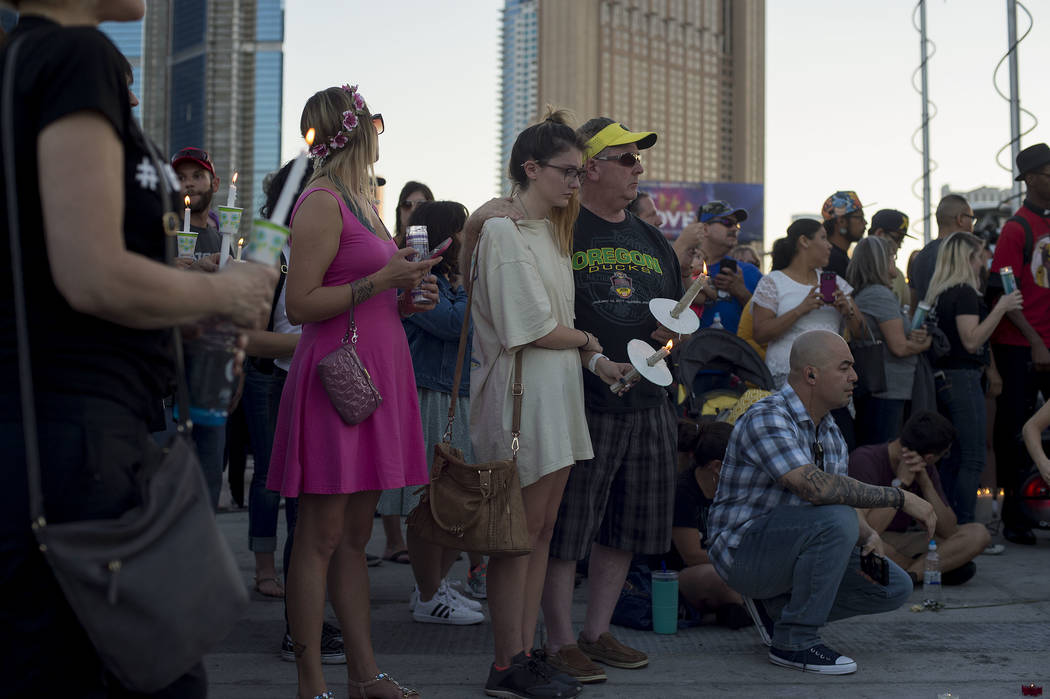 Attendees gather for vigil in honor of the victims exactly one week after the Oct. 1, 2017 mass shooting on the corner of Sahara Avenue and Las Vegas Boulevard in Las Vegas, Sunday, Oct. 8, 2017.  ...