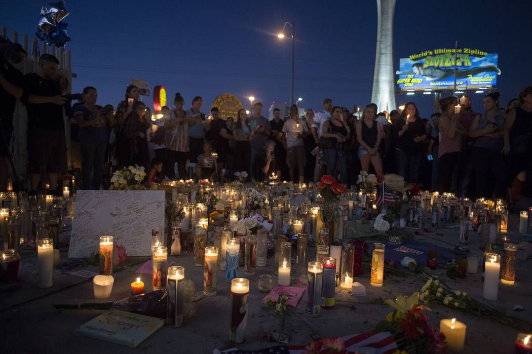 Attendees gather for vigil in honor of the victims exactly one week after the Oct. 1, 2017 mass shooting on the corner of Sahara Avenue and Las Vegas Boulevard in Las Vegas, Sunday, Oct. 8, 2017.  ...