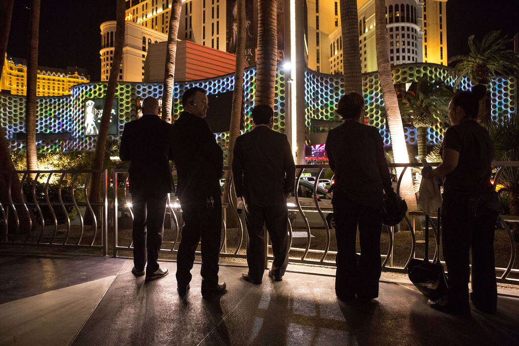 Hotel employees step outside to see marquees on the Strip go dark one week after the Oct. 1, 2017 mass shooting in Las Vegas, Sunday, Oct. 8, 2017. Bridget Bennett Las Vegas Review-Journal @Bridge ...