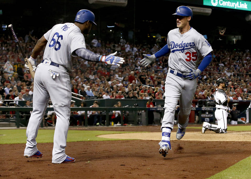 Los Angeles Dodgers Cody Bellinger (35) greets Yasiel Puig (66) after hitting a solo home run during the fifth inning of game 3 of baseball's National League Division Series, Monday, Oct. 9, 2017, ...