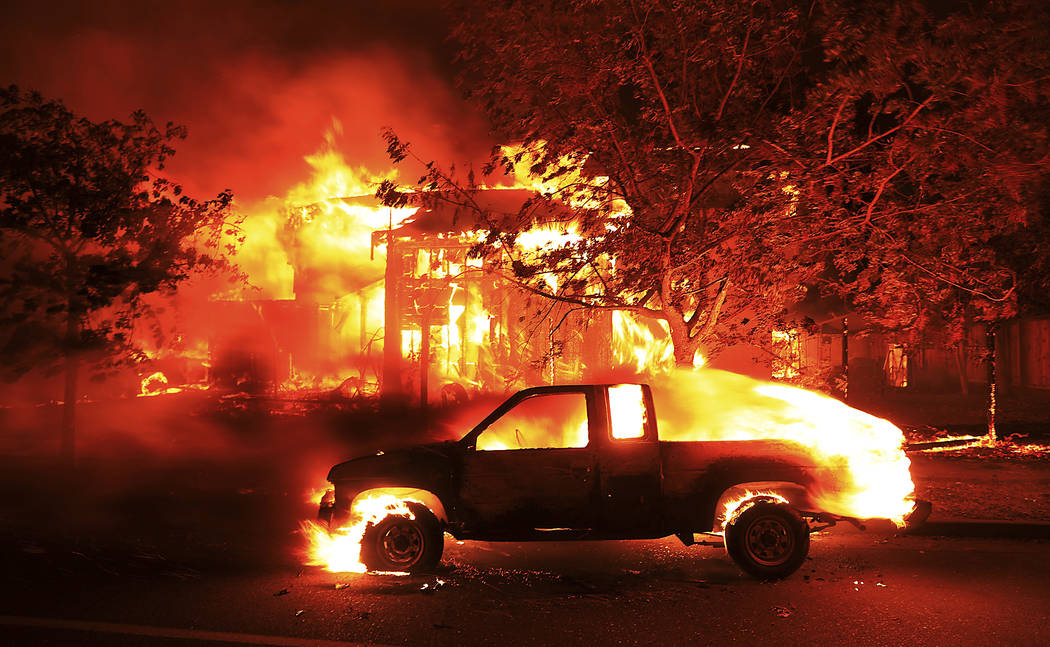 Coffey Park homes burn early Monday Oct. 9, 2017 in Santa Rosa, Calif. More than a dozen wildfires whipped by powerful winds been burning though California wine country. The flames have destroyed  ...