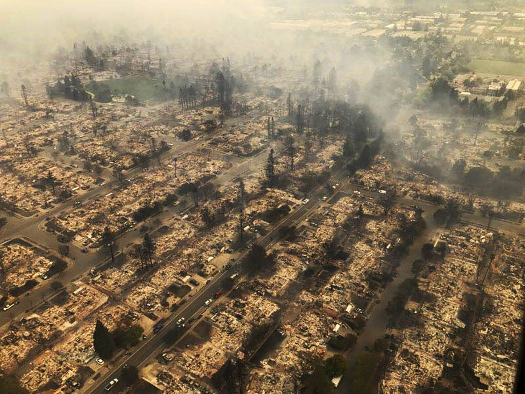 This aerial photo provided by the California Highway Patrol Golden Gate Division shows some of hundreds of homes destroyed in a wind-driven wildfire that swept through Santa Rosa, Calif., early Mo ...